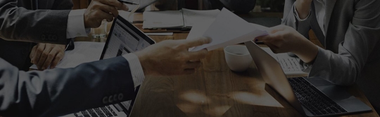 men in suits, documents, table, laptop
