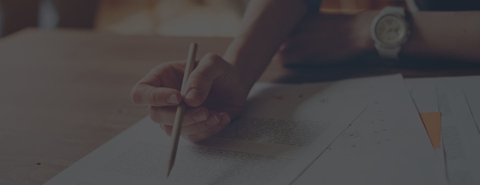 Client pointing to legal documents on the table.